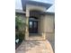 Inviting front entrance features a double door entry, arched portico and brick paver walkway at 2031 Basin St, Port Charlotte, FL 33952