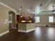 Open concept living and kitchen area features a large island with pendant lighting and modern finishes at 2031 Basin St, Port Charlotte, FL 33952