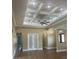 Open living area with tray ceilings, recessed lighting, and archway accents at 2031 Basin St, Port Charlotte, FL 33952