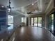 Bright living room features a tray ceiling, recessed lighting and sliding glass doors to pool at 2031 Basin St, Port Charlotte, FL 33952