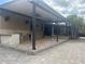 Covered outdoor kitchen and patio featuring built-in grill, sink, and brick pavers at 2031 Basin St, Port Charlotte, FL 33952