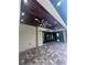 Covered patio with brick pavers, ceiling fans, and sliding glass doors to the interior at 2031 Basin St, Port Charlotte, FL 33952