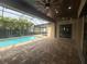 Screened in outdoor pool with brick patio, palm trees and dark wood ceiling with fans at 2031 Basin St, Port Charlotte, FL 33952
