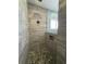 Tiled shower with stone pebble floor and a built-in niche at 2031 Basin St, Port Charlotte, FL 33952
