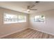 Bedroom with light wood floors, ceiling fan, white walls, and lots of natural light from the windows at 219 Glen Oak Rd, Venice, FL 34293