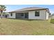 Lush backyard featuring a screened-in patio area with ample space and a well-manicured lawn leading to the home at 23218 Fawn Ave, Punta Gorda, FL 33980