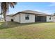 Expansive backyard showcasing a well-maintained lawn and a screened-in patio area for outdoor enjoyment at 23218 Fawn Ave, Punta Gorda, FL 33980