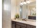 Bathroom vanity with double sinks and granite countertops and large mirror at 23218 Fawn Ave, Punta Gorda, FL 33980