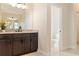 Bathroom vanity with double sinks and granite countertops and large mirror at 23218 Fawn Ave, Punta Gorda, FL 33980