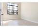 Bright bedroom with tile flooring, a large window, neutral paint, and base molding at 23218 Fawn Ave, Punta Gorda, FL 33980