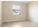 Bright bedroom with tile floors and a large window providing natural light and views of the surrounding area at 23218 Fawn Ave, Punta Gorda, FL 33980