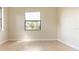 Bright bedroom with large window providing a view of the outdoor landscape at 23218 Fawn Ave, Punta Gorda, FL 33980