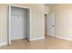 Bedroom with a closet and a doorway, featuring neutral walls and tile flooring throughout the space at 23218 Fawn Ave, Punta Gorda, FL 33980