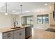 Stylish kitchen with granite countertops, stainless steel appliances, and a view of the backyard through large windows at 23218 Fawn Ave, Punta Gorda, FL 33980