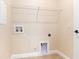 Functional laundry room with tile flooring, a wire shelf, and visible utility connections for appliances at 23218 Fawn Ave, Punta Gorda, FL 33980