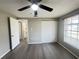 Bright bedroom with a ceiling fan, wood-look floors, a window, and a closet with plenty of storage space at 2507 Linton Ln, Port Charlotte, FL 33952