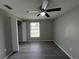 Bedroom with gray walls and floors, ceiling fan and closet at 2507 Linton Ln, Port Charlotte, FL 33952