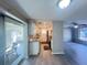 Bright kitchen adjacent to the living room and patio featuring granite countertops and white cabinets at 2507 Linton Ln, Port Charlotte, FL 33952
