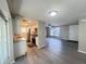 Open concept living room and kitchen features hardwood floors, bright natural light, and a front door at 2507 Linton Ln, Port Charlotte, FL 33952
