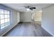 Open living space with gray wood flooring, ceiling fan, and natural light at 2507 Linton Ln, Port Charlotte, FL 33952