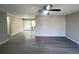 Spacious living room with new gray wood flooring and natural light from sliding patio doors at 2507 Linton Ln, Port Charlotte, FL 33952