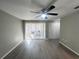 Spacious living room with access to a patio, featuring gray flooring and a ceiling fan at 2507 Linton Ln, Port Charlotte, FL 33952