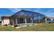 Enjoy outdoor living in this fenced yard featuring a screened in pool and surrounding landscaping at 30035 Alder Rd, Punta Gorda, FL 33982