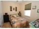 Cozy bedroom with a colorful quilt, bedside table, window, and décor at 30035 Alder Rd, Punta Gorda, FL 33982