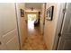 Hallway view with tile flooring leading to a living area, offering a glimpse into the home's layout at 30035 Alder Rd, Punta Gorda, FL 33982