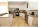 Well-lit kitchen featuring stainless steel appliances, white cabinetry, and granite countertops at 30035 Alder Rd, Punta Gorda, FL 33982
