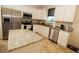 Bright kitchen features white cabinets, granite countertops, and stainless steel appliances at 30035 Alder Rd, Punta Gorda, FL 33982
