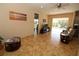 Bright living room with tile floors and sliding glass doors to a screened in porch, offering indoor-outdoor living at 30035 Alder Rd, Punta Gorda, FL 33982
