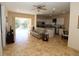 Inviting living space with tile flooring flowing into the kitchen area, with seamless access to outdoor living at 30035 Alder Rd, Punta Gorda, FL 33982