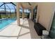 Covered patio overlooking pool with ceiling fan and comfortable seating area at 30035 Alder Rd, Punta Gorda, FL 33982