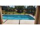 Beautiful pool with clear water and lush landscaping in a screened enclosure at 30035 Alder Rd, Punta Gorda, FL 33982