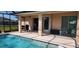 Relax and enjoy the sparkling waters of this screened-in pool and covered patio at 30035 Alder Rd, Punta Gorda, FL 33982