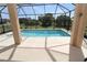 Screened-in pool area with lush landscaping, sparkling blue water, and covered patio at 30035 Alder Rd, Punta Gorda, FL 33982