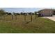 View of a home's side yard with partial fencing and greenery, offering a glimpse of the outdoor perimeter at 30035 Alder Rd, Punta Gorda, FL 33982