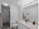 Bright bathroom with a large mirror, a white toilet, and a shower with white tiling at 3213 Belleville Ter, North Port, FL 34286