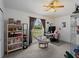 Bedroom featuring neutral carpet, ceiling fan, and ample desk space near the window at 3213 Belleville Ter, North Port, FL 34286