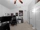Bedroom featuring a ceiling fan, a large tv on a desk, and a closet at 3213 Belleville Ter, North Port, FL 34286