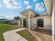 Attractive front entrance featuring a vibrant flower bush and decorative rock landscaping at 3213 Belleville Ter, North Port, FL 34286