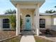 Charming front entrance featuring a decorative blue door and lush landscaping at 3213 Belleville Ter, North Port, FL 34286