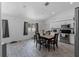 Eat-in kitchen boasts wood-look tile flooring, stainless steel appliances, white cabinets and ample sunlight at 3213 Belleville Ter, North Port, FL 34286