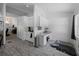 Additional kitchenette area featuring white cabinetry, marble countertops and wood-look tile floors at 3213 Belleville Ter, North Port, FL 34286