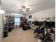 Spacious living room with ceiling fan, shelving units, guitars, and multiple computer setups at 3213 Belleville Ter, North Port, FL 34286
