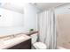 Bathroom with a toilet, vanity sink, a mirror and a shower with a curtain at 3310 Loveland Blvd # 1808, Punta Gorda, FL 33980