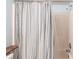 Shower and bath with a striped curtain and shower head at 3310 Loveland Blvd # 1808, Punta Gorda, FL 33980