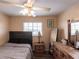 Neutral bedroom with ceiling fan, flooring, and a mirror on top of the dresser at 3310 Loveland Blvd # 1808, Punta Gorda, FL 33980