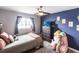 Cozy bedroom features a ceiling fan, and large window with gray curtain at 3310 Loveland Blvd # 1808, Punta Gorda, FL 33980